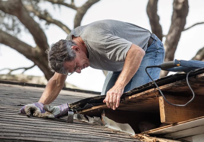 Man Examining his Shed roof repair